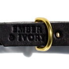 Detail of black leather and brass hardware