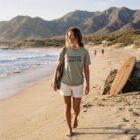 Todos Santos tee — Baja California Mexico graphic tee Heather Stone walking on beach